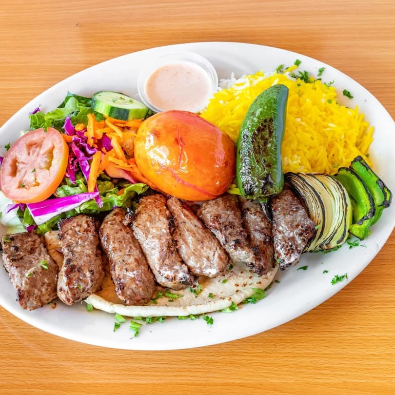 Fanoos Grill's Persian koobideh kebab with saffron rice, grilled vegetables, and fresh salad.
